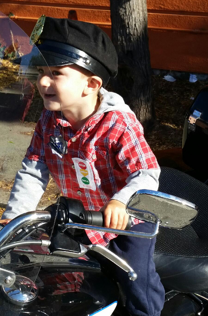 Someone is excited to be on a police bike!