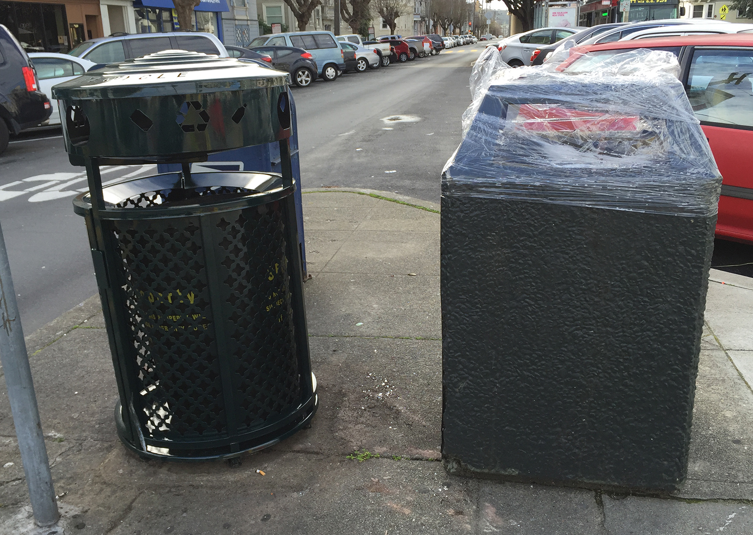 The new public garbage can (L) showing up on the streets of the Richmond District