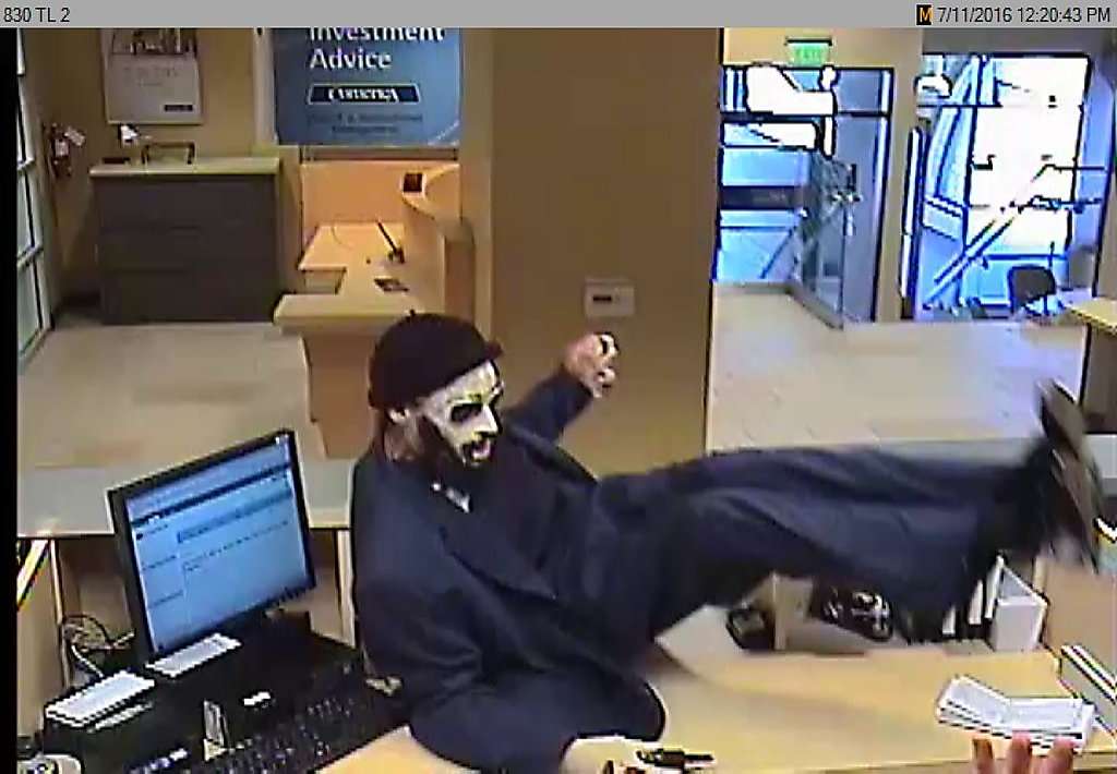 The “Dreaded Bandit” is seen on a security camera jumping the counter of a Bay Area bank.