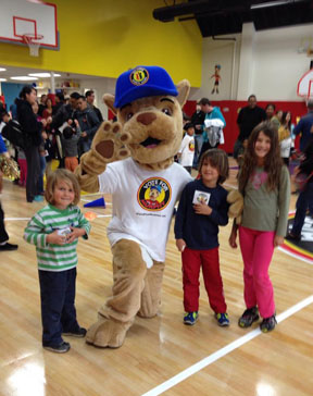 Murphy, Hi-Five's mascot, poses with players