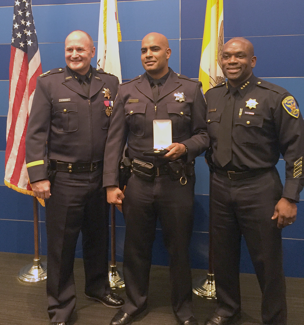 San Francisco Police Officer Riley Bandy (center) receives the Oakland PD Silver Star for bravery.