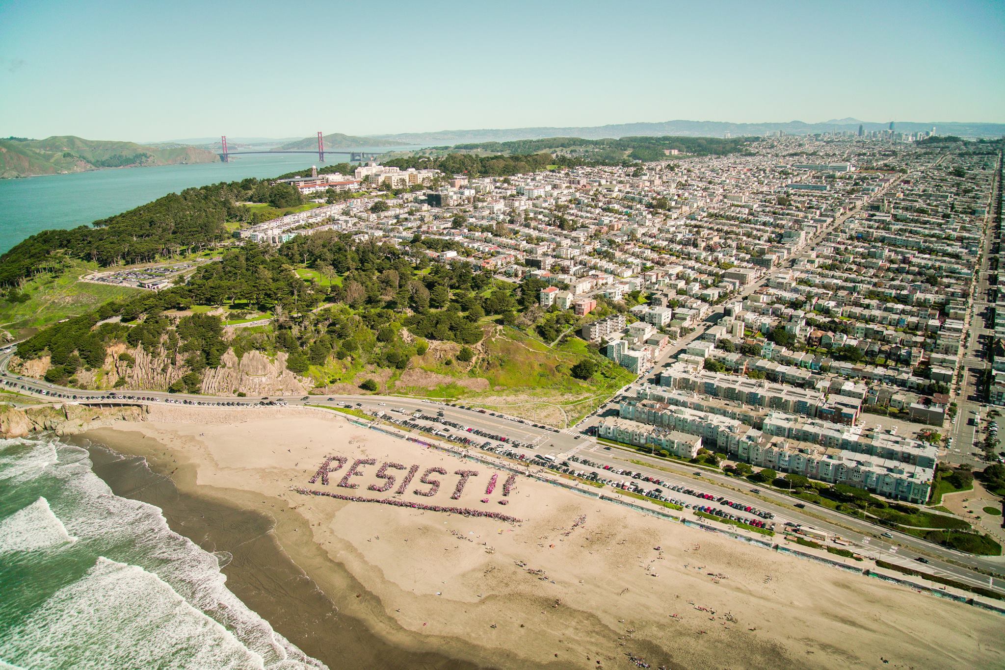 Thousands Come To Ocean Beach To Spell Out RESIST Richmond 